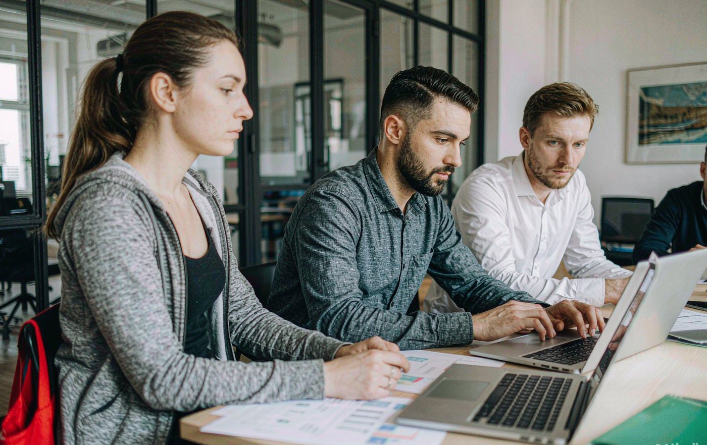 Team collaborating around a table in a bright, modern office